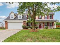 Charming two-story home featuring a spacious front porch, red shutters, and a well-manicured lawn at 4434 W Windsong Ct, New Palestine, IN 46163