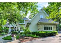 Charming two-story home featuring stone accents, lush landscaping, and a welcoming front porch at 4530 Chase Oak Ct, Zionsville, IN 46077