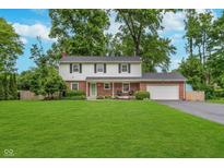 Charming two-story home with a well-manicured lawn and beautiful landscaping at 4840 E 77Th St, Indianapolis, IN 46250