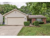 Charming single-story home featuring a garage and a combination of brick and light siding at 6010 Rocky River Dr, Indianapolis, IN 46221