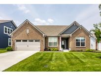Beautiful brick home featuring a well-manicured lawn, attached garage and inviting curb appeal at 9718 Haughton Ln, McCordsville, IN 46055