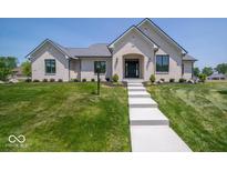 Beautifully landscaped, single-story white brick home featuring a manicured lawn at 10586 Jacks Way, Indianapolis, IN 46234
