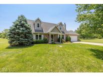 Charming two-story home with well-manicured lawn, dormer windows, and brick accents at 1135 W Wildflower Ct, Mooresville, IN 46158