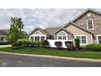 Charming home with stone accents, large windows, and well-manicured landscaping at 1150 Extraordinary Trl, Greenfield, IN 46140