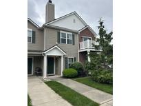 Charming townhouse featuring a mix of vinyl siding and brick accents, with a private balcony and well-manicured landscaping at 13225 Deception Pass # 1200, Fishers, IN 46038