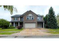 Charming two-story home featuring a brick facade, attached two-car garage, and well-manicured landscaping at 16247 Countryside Blvd, Westfield, IN 46074