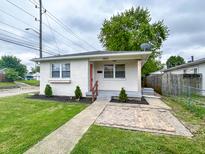 Inviting one-story house with a tidy front yard and stylish, painted brick exterior at 1653 Wade St, Indianapolis, IN 46203