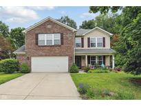 Charming two-story home with brick and siding, a two-car garage, and a landscaped front yard at 16732 Maraschino Dr, Noblesville, IN 46062