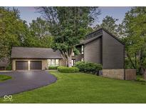 Beautiful home with a two-car garage and a large front yard with mature trees at 20322 Wagon Trail Dr, Noblesville, IN 46060