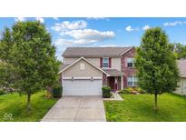 Charming two-story home featuring brick and siding, a two-car garage, and a well-maintained front yard at 2509 Cedarmill Dr, Franklin, IN 46131