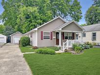 Charming single-story home with neutral siding, red shutters, a well-maintained lawn, and detached one-car garage at 2612 E Northgate St, Indianapolis, IN 46220