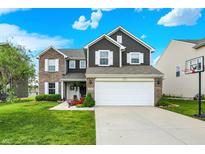 Charming two-story home with a well-manicured lawn, inviting curb appeal, and a two-car garage at 3284 Clary Blvd South Dr, Greenwood, IN 46143