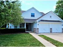 Charming two-story home with a well-manicured lawn, attached two-car garage, and inviting front porch at 3862 Cornwallis Ln, Carmel, IN 46032
