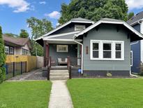 Charming craftsman-style home with a well-manicured lawn and inviting front porch at 4345 Guilford Ave, Indianapolis, IN 46205