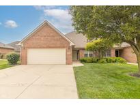 Charming brick home with an attached two-car garage and a well-maintained front yard at 4725 W Harrisburg Ct, New Palestine, IN 46163