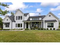 Stunning two-story white home with black trim and a meticulously landscaped front yard at 4808 Lakeview Dr, Greenwood, IN 46143