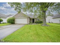 Charming brick home featuring a well-maintained lawn and mature tree, enhancing its curb appeal at 7724 Blackthorn Dr, Indianapolis, IN 46236