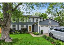 Charming two-story home with gray siding, white trim, and a well-manicured front lawn at 8272 Calgary Ct, Indianapolis, IN 46268