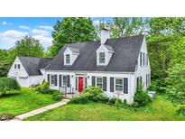 Charming white two-story home with a red front door and well-manicured lawn at 8301 E County Road 801 S, Plainfield, IN 46168