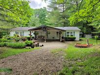 Charming single story home featuring a covered porch and meticulous landscaping at 8310 Dog Trot Ln, Morgantown, IN 46160
