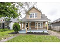 Charming home featuring a cozy front porch, well-maintained lawn, and attractive landscaping at 839 N Oxford St, Indianapolis, IN 46201