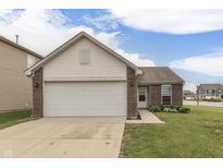 Charming single-Gathering home with a two-car garage, brick accents, and well-maintained lawn at 933 Curlew Ln, Greenwood, IN 46143