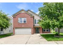 Two-story home with brick and siding, attached two car garage and beautiful green yard with mature trees at 9358 W Rising Sun Dr, Pendleton, IN 46064
