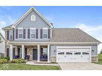 Charming two-story home with a well-manicured lawn, welcoming front porch, and a two-car garage at 10284 Legacy Dr, Brownsburg, IN 46112