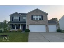 Charming two-story home featuring a three car garage, brick and siding facade, and well-manicured lawn at 1287 Highland Lake Way, Brownsburg, IN 46112