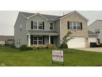 Charming two-story home with a combination of vinyl siding and brick facade, complemented by well-maintained landscaping at 1287 Highland Lake Way, Brownsburg, IN 46112