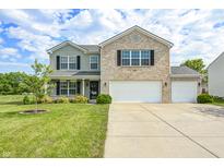 Charming two-story home featuring brick and siding, with a well-manicured lawn and two-car garage at 1287 Highland Lake Way, Brownsburg, IN 46112