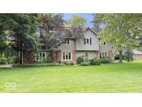 Charming two-story home boasts a well-manicured lawn, brick accents, and neutral siding for a welcoming curb appeal at 13297 Highland Springs Dr, McCordsville, IN 46055