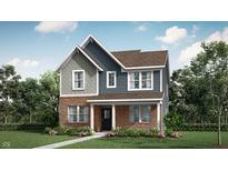 Charming two-story home with brick and blue siding and a well-manicured lawn at 15395 Alperton Rd, Fishers, IN 46037