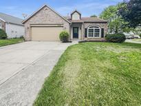 Charming one-story brick home with a well-maintained lawn and an attached garage at 2035 Theodore Dr, Indianapolis, IN 46214