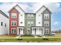 Charming townhomes with colorful siding and inviting front porches on a clear, blue-sky day at 2412 Peoples Dr, Indianapolis, IN 46205
