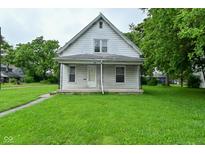 Charming home featuring a covered front porch and a well-maintained grassy lawn at 2622 Ethel Ave, Indianapolis, IN 46208