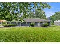 Charming single-story home featuring blue brick exterior and well-manicured lawn at 3735 Marrison Pl, Indianapolis, IN 46205