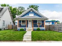 Charming blue home featuring a quaint front porch, well-maintained lawn, and welcoming curb appeal at 3764 Ruckle St, Indianapolis, IN 46205