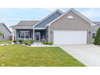 Charming one-story home with blue siding, brick accents, well-kept lawn, and attached two-car garage at 485 Thunderwood Dr, Greenfield, IN 46140