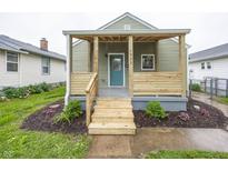 Charming home featuring a covered front porch and landscaped yard with newly installed steps at 4933 W 13Th W St, Speedway, IN 46224