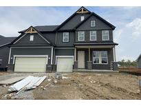 New two-story home with gray siding, brick accents, and an attached two car garage at 4988 Elaine Ct, Noblesville, IN 46062
