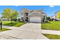 Charming two-story home featuring a brick facade, well-manicured lawn, and a spacious driveway at 515 Lynton Way, Westfield, IN 46074