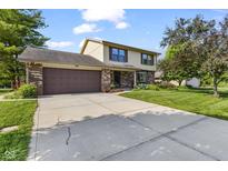 Charming two-story home featuring a brick and vinyl exterior, lush landscaping, and an attached two-car garage at 5325 Ridge Hill Way, Avon, IN 46123