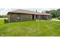 Charming brick home featuring a lush lawn and well-maintained landscaping at 5905 N County Rd 600 E, Brownsburg, IN 46112