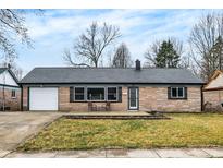 Charming single-story home with a brick facade, attached garage, and cozy front porch area at 634 Park Dr, Greenwood, IN 46143