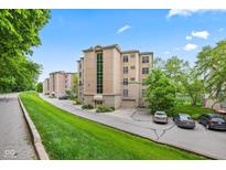 An attractive residential building with a manicured lawn is nestled in lush greenery at 6760 Spirit Lake Dr # 201, Indianapolis, IN 46220