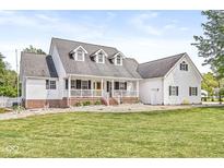 Charming two-story home with covered porch, dormer windows, landscaped yard and a lovely, classic design at 7221 State Road 42, Martinsville, IN 46151