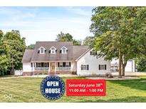 Charming home featuring a welcoming front porch, well-manicured lawn, and a classic design with dormer windows at 7221 State Road 42, Martinsville, IN 46151