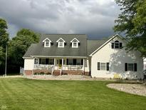 Charming two-story home with a inviting front porch and well-maintained lawn at 7221 State Road 42, Martinsville, IN 46151