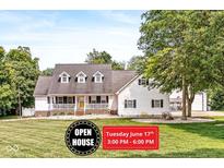Charming two-story home with a welcoming front porch and well-manicured lawn at 7221 State Road 42, Martinsville, IN 46151